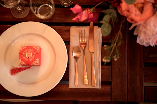 Cutlery plate knife and forks glass on table setting and flowers